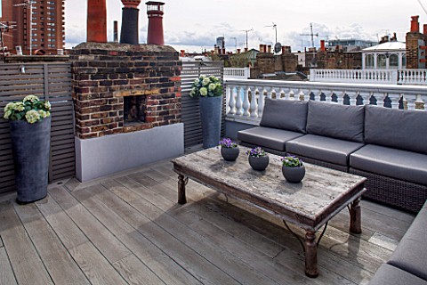 SALLY_STOREY_HOUSE_LONDON_ROOF_TERRACE_WITH_FAKE_WOODEN_DECKING_LOUNGERS_AND_WOODEN_TABLE_FAKE_HYDRA