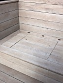 SALLY STOREY HOUSE, LONDON: ROOF TERRACE WITH FAKE WOODEN DECKING AND LID OF STORAGE AREA WITH HOLES FOR FINGERS TO LIFT LID. ROOF GARDEN, DECK, TOWN GARDEN, MODERN