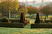 PETTIFERS, OXFORDSHIRE: DESIGNED  BY GINA PRICE: THE PARTERRE IN EARLY SPRING - APRIL - HEDGE, HEDGING, ENGLISH GARDEN, MORNING LIGHT, SUNRISE, FORMAL, BOX HEDGE, BOX HEDGING