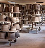 WHICHFORD POTTERY, WARWICKSHIRE: JUST MADE TERRACOTTA CONTAINERS DRYING OUT ON WOODEN RACKS  - DECORATION,  DECORATIVE, ORNAMENT, GARDEN