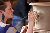 WHICHFORD POTTERY, WARWICKSHIRE: SAS COOPER FETTLING THE TUDOR ROSE DESIGN ON QUEENS 90TH BIRTHDAY TERRACOTTA CONTAINER IN WORKSHOP