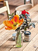 WHICHFORD POTTERY, WARWICKSHIRE: THE CAFE - WOODEN TABLE AND CHAIRS WITH GLASS VASE  FILLED WITH FLOWERS - ORANGE TULIP