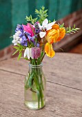 WHICHFORD POTTERY, WARWICKSHIRE: THE CAFE - WOODEN TABLE WITH GLASS VASE FILLED WITH FLOWERS - ORANGE TULIP, SNAKES HEAD FRITILLARY AND BLUEBELLS