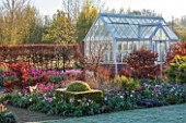 ULTING WICK, ESSEX: LAWN IN FROST WITH TULIPS, BEECH HEDGE AND GREENHOUSE. SPRING, APRIL, BULBS, COLD, GLASS HOUSE, GLASSHOUSE, BOX, TOPIARY