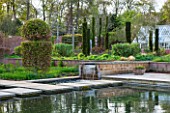 BROUGHTON GRANGE, OXFORDSHIRE: POOL AND RILL WITH WATERFALL AND STEPPING STONES IN THE WALLED GARDEN IN MAY. ENGLISH, GARDEN, HEDGING, GREENHOUSE, BEECH