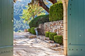 LA JEG, PROVENCE, FRANCE: STONE STEPS, BLUE WOODEN GATES, STONE WALL, RILL, FOUNTAIN, BOX HEDGING - BUXUS, CLIPPPED, TOPIARY, WATER, MEDITERRANEAN, ENTRANCE, GATEWAY, FRAME