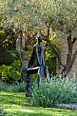 LA JEG, PROVENCE, FRANCE: DESIGNER ANTHONY PAUL - LAWN WITH SCULPTURE BY HELEN SINCLAIR. ORNAMENT, MEDITERRANEAN, FORMAL, GARDEN, OLIVE TREE