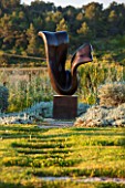 LA JEG, PROVENCE, FRANCE: DESIGNER ANTHONY PAUL - GRASS PATH AND SCULPTURE BY MARZIA COLONNA. SPRING. MEDITERRANEAN, GARDEN, GREEN, PROVENCE, MAY