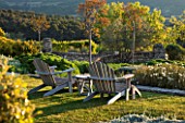 LA JEG, PROVENCE, FRANCE: DESIGNER ANTHONY PAUL - WOODEN ADIRONDACK CHAIRS ON LAWN. BENCH, LOUNGER, LOUNGERS, SPRING. MEDITERRANEAN, GARDEN, GREEN, PROVENCE, MAY