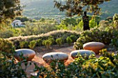 LA JEG, PROVENCE, FRANCE: DESIGNER ANTHONY PAUL - PATH WITH CERAMIC SEATS BY HANNAH BENNET. SPRING. MEDITERRANEAN, GARDEN, GREEN, PROVENCE, MAY, SCULPTURE