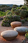 LA JEG, PROVENCE, FRANCE: DESIGNER ANTHONY PAUL - PATH WITH CERAMIC SEATS BY HANNAH BENNET. SPRING. MEDITERRANEAN, GARDEN, GREEN, PROVENCE, MAY, SCULPTURE, CISTUS