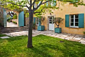 LA JEG, PROVENCE, FRANCE: DESIGNER ANTHONY PAUL - COURTYARD, HOUSE, LAWN, PAVING, STONE, PATH, VERSAILLES CONTAINER, SPRING, MEDITERRANEAN, ARCHWAY, GATE