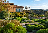 LA JEG, PROVENCE, FRANCE: DESIGN: ANTHONY PAUL - THE HOUSE WITH BLUE SHUTTERS. CLIPPED PLANTS, CISTUS, SUMMER,  COUNTRY, GARDEN