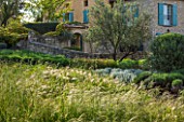 LA JEG, PROVENCE, FRANCE: DESIGN: ANTHONY PAUL - THE HOUSE WITH BLUE SHUTTERS, MEADOW, OLIVE TREE, STONE WALL, SUMMER,  COUNTRY, GARDEN
