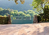 LA JEG, PROVENCE, FRANCE: DESIGN: ANTHONY PAUL - FRONT DRIVE WITH BLUE WOODEN GATES, GATE, ENTRANCE, SUMMER,  COUNTRY, GARDEN