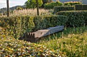 LA JEG, PROVENCE, FRANCE: DESIGNER ANTHONY PAUL -  HEDGE AND WAVE SEAT IN GREEN OAK. WOOD, WOODEN, BENCH, CHAIR, A PLACE TO SIT, SPRING. MEDITERRANEAN, GARDEN, GREEN, PROVENCE, MAY