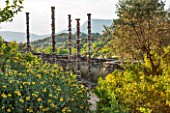 LA JEG, PROVENCE, FRANCE: DESIGN: ANTHONY PAUL - PATH, PHLOMIS, SCULPTURE - SILENT COLUMNS BY CHRIS BOOTH, WALL, STONE, SUMMER,  COUNTRY, GARDEN