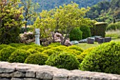 LA JEG, PROVENCE, FRANCE: DESIGNER ANTHONY PAUL - STONE WALL AND CLIPPED TOPIARY. MEDITERRANEAN, GARDEN, PROVENCE, MAY, CLOUD, PRUNED, HEDGING, HEDGE