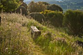 LA JEG, PROVENCE, FRANCE: DESIGNER ANTHONY PAUL - GRASS PATH AND SEAT, ANTHONY PAUL BENCH OF GREEN OAK, SPRING, MEDITERRANEAN