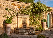 LA JEG, PROVENCE, FRANCE: DESIGNER ANTHONY PAUL - WALLED GARDEN WITH RILL AND FOUNTAIN. PAVING, STONE, MEDITERRANEAN, WATER, GARDEN, SPRING, MAY, TERRACOTTA, CONTAINER