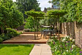 PRIVATE GARDEN LONDON DESIGNED BY LUCY WILLCOX AND ANA SANCHEZ MARTIN: TOWN GARDEN WITH LAWN, PATH, WALL, PERGOLA, BORDERS, SEAT - JUNE, SUMMER, FORMAL, TABLE, CHAIRS