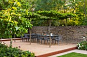 PRIVATE GARDEN LONDON DESIGNED BY LUCY WILLCOX AND ANA SANCHEZ MARTIN: TOWN GARDEN - PATIIO AREA WITH PLEACHED TREE CANOPY / PERGOLA, TABLE, CHAIRS, WALL, SUMMER, FORMAL