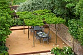 PRIVATE GARDEN LONDON DESIGNED BY LUCY WILLCOX AND ANA SANCHEZ MARTIN: TOWN GARDEN - PATIIO AREA WITH PLEACHED TREE CANOPY / PERGOLA, TABLE, CHAIRS, WALL, SUMMER, FORMAL