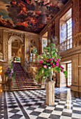 CHATSWORTH HOUSE, DERBYSHIRE:FLORABUNDANCE-THE PAINTED HALL DECORATED 1687-1694 BY LOUIS LAGUERRE BEAUTIFUL FLORAL DISPLAY ON STONE PLINTH. INTERIOR, OPULENCE, GRAND, STAIRCASE