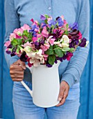 THE REAL FLOWER COMPANY:WOMAN HOLDING WHITE JUG OF SWEET PEAS. FLOWERS,FLORAL,ARRANGEMENT,VASE,FRAGRANT,SHABBY CHIC,VINTAGE,PRETTY,SUMMER