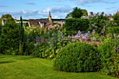 GREYHOUNDS, BURFORD, OXFORDSHIRE:COUNTRY GARDEN & COTTAGE BORDER WITH VALERIANA OFFICINALIS, CAMPANULA VARS & ERYNGIUM BOURGATII. WITH BOX DOMES & YEW TOPIARY. SUMMER, LILAC,PURPLE
