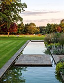 PRIVATE GARDEN, GLOUCESTERSHIRE DESIGNED BY MARCUS BARNETT: SUMMER, GARDEN, COTSWOLDS, CANAL, WATER, POOL, BORROWED LANDSCAPE, LLAMAS