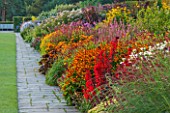 RHS GARDEN, WISLEY, SURREY: THE FAMOUS DOUBLE MIXED BORDER IN SUMMER STRETCHING 128 METRES DOWN THE HILL - GRASS, PERENNIALS, SUMMER, GARDEN, CLASSIC, PERENNIAL, HERBACEOUS