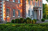 MORTON HALL GARDENS, WORCESTERSHIRE: THE FRONT OF THE HALL WITH BOX TOPIARY SHAPES - DAWN LIGHT, MORNING, ENGLISH, GARDEN, CLASSIC, TOPIARY, SUMMER