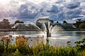 ROYAL BOTANIC GARDENS, KEW: FOUNTAIN, LAKE AND VICTORIAN PALM HOUSE IN AUTUMN - AFTERNOON LIGHT, IRON, GLASS, WATER, ORNAMENT, SKY, DRAMATIC