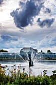 ROYAL BOTANIC GARDENS, KEW: FOUNTAIN, LAKE AND VICTORIAN PALM HOUSE IN AUTUMN - AFTERNOON LIGHT, IRON, GLASS, WATER, ORNAMENT, SKY, DRAMATIC