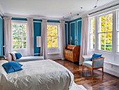 MORTON HALL, WORCESTERSHIRE: MASTER BEDROOM WITH EAST FACING WINDOWS. WALLS ARE FARROW & BALL CHINESE BLUE WITH MOULDINGS IN FB ALL WHITE. WOODEN FLOOR AND FURNITURE.