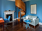 MORTON HALL, WORCESTERSHIRE: STUDY. PAINTED FB COOKS BLUE.19TH CENTURY FIREPLACE.SOFABED JAMES BY MILANO.SPIRAL STAIRCASE IN BRUSHED STEEL & SMOKED OAK BY CARL GEORG LUETCKE