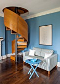MORTON HALL, WORCESTERSHIRE: STUDY. PAINTED FB COOKS BLUE SOFABED JAMES BY MILANO.SPIRAL STAIRCASE IN BRUSHED STEEL & SMOKED OAK BY CARL GEORG LUETCKE