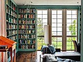 MORTON HALL, WORCESTERSHIRE: LIBRARY WITH SHELVES BY WIENER WERKSTAETTEN, PAINTED IN FB DIX BLUE. DOORS OUT ONTO SOUTH GARDEN.LECTERN IN CHERRY WOOD.