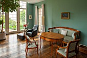 MORTON HALL,WORCESTERSHIRE:GARDEN ROOM PAINTED IN FB DIX BLUE.FRENCH DOORS, OVAL TABLE CA. 1820,SOUTHERN GERMAN.ARMCHAIRS IN WALNUT, CA. 1825 SOUTH WEST GERMAN. WOODEN FLOOR