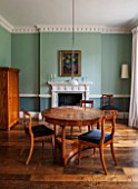 MORTON HALL, WORCESTERSHIRE:BREAKFAST ROOM (FORMER LIBRARY). PAINTED FB GREEN BLUE & OVAL ROOM BLUE. CIRCULAR WALNUT TABLE & CHERRY WOOD DINING CHAIRS CA.1825