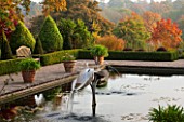 BORDE HILL GARDEN, WEST SUSSEX. AUTUMN. OCTOBER, FALL. THE ITALIAN GARDEN WITH TERRACOTTA CONTAINERS, FOUNTAIN AND POOL. POND, WATER