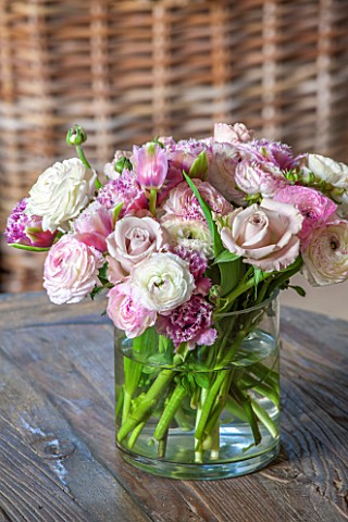 THE_COACH_HOUSESURREY_DETAIL_OF_FRESH_RANUNCULUS_ROSES_AND_TULIPS_IN_VASE_ON_COFFEE_TABLE_PRETTY_DEC