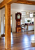 THE COACH HOUSE,SURREY: LARGE ROOM WITH OAK BEAMS, CONSOLE TABLE FROM CHRISTIES, GRANDFATHER CLOCK INHERITED FROM FAMILY, WOODEN FLOOR
