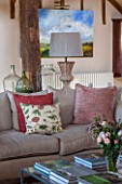 THE COACH HOUSE,SURREY: FAMILY ROOM WITH SOFAS AND COFFEE TABLE, CUSHIONS FROM CHELSEA TEXTILES, LAMP BY OKA.