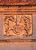 BURTON AGNES HALL, EAST YORKSHIRE: CHRISTMAS - CARVED STONEWORK DETAIL ON THE GATEHOUSE DEPICTING JAMES 1ST COAT OF ARMS. DETAIL, ORNAMENT, MORNING LIGHT