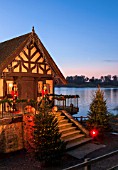 BLENHEIM PALACE, OXFORDSHIRE, WINTER, CHRISTMAS - THE BOAT HOUSE BY THE LAKE LIT UP AT NIGHT - LIGHTING, DECORATIV, CHRISTMAS TREE, TREES, SUNSET, DUSK, WINTER, ILLUMINATED