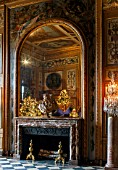 VAUX LE VICOMTE, FRANCE: THE DINING ROOM DECORATED FOR CHRISTMAS. THE MARBLE FIREPLACE, MIRROR, BUST OF LE BRUN, PAINTER TO THE KING