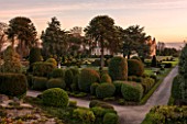 BRODSWORTH HALL, YORKSHIRE: THE FRONT OF THE HALL AT DAWN. WINTER, JANUARY, TOPIARY EVERGREEN BORDER, MONKEY PUZZLE TREE, FORMAL, GARDEN, COUNTRY