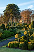 BRODSWORTH HALL, YORKSHIRE: DAWN. WINTER, JANUARY, TOPIARY EVERGREEN, BORDER, FORMAL, GARDEN, COUNTRY, CLIPPED, HOLLY, CEDAR OF LEBANON, ITALIANATE SUMMERHOUSE, LAWN